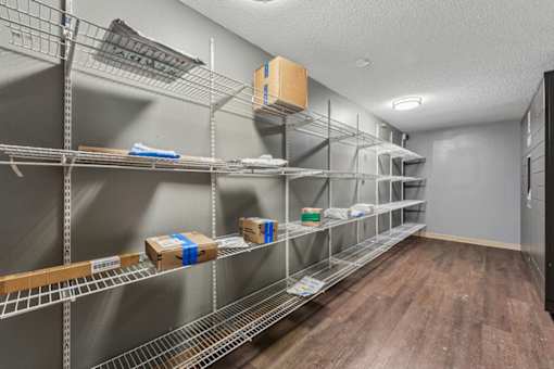 A long metal shelving unit with boxes on it.