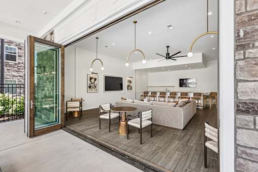 A modern living room with a glass door leading to a balcony.