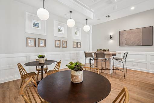 A dining room with a round table and chairs.