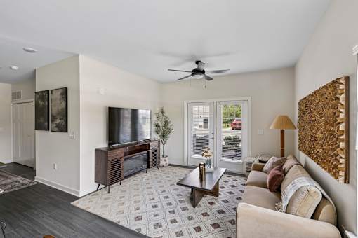 A living room with a grey tiled floor and a brown sofa.