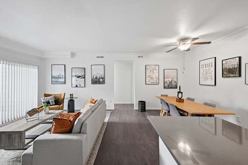 A living room with a grey couch and a wooden table.
