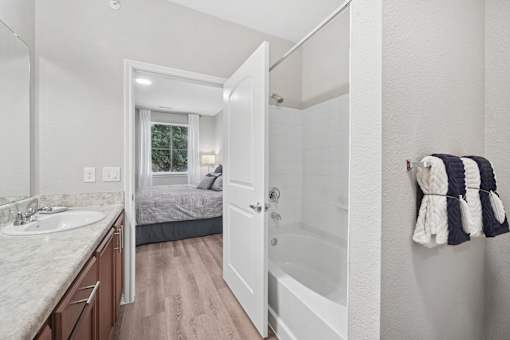 A bathroom with a white sink and a white tub.