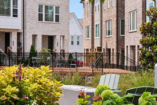 A row of houses with a black fence in front.