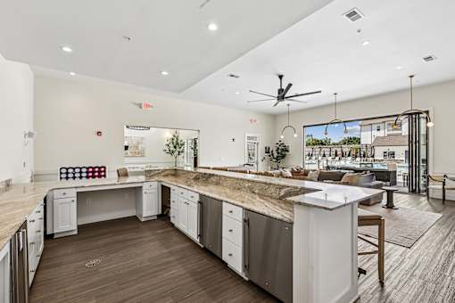 A modern kitchen with a large island and stainless steel appliances.
