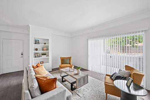 A living room with a grey couch, a yellow chair, and a coffee table.