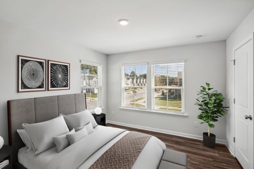 a bedroom with a bed and three windows