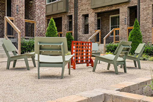 A set of four chairs are arranged in a circle on a patio.