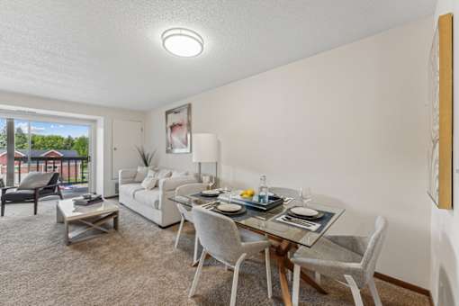 A dining room with a glass table and chairs.