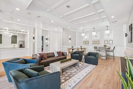 A living room with a white ceiling and a rug on the floor.
