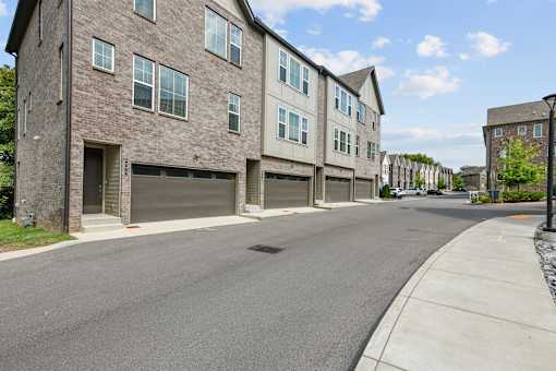 A street view of a residential area with houses on both sides.