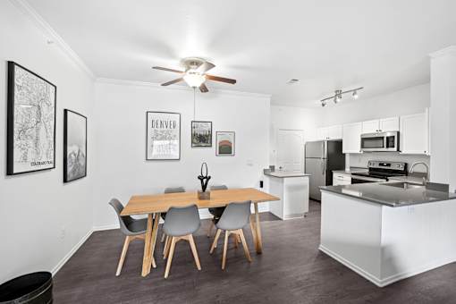 A modern kitchen with a dining table and chairs.