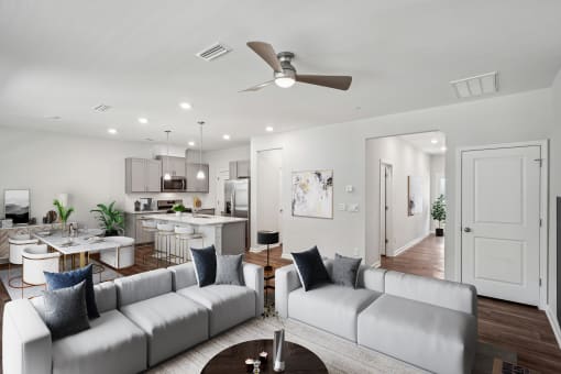 an open living room and kitchen with couches and a table