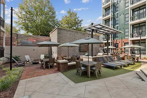 A patio with a table and chairs under a canopy.