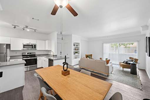 A modern kitchen with a dining table and chairs.