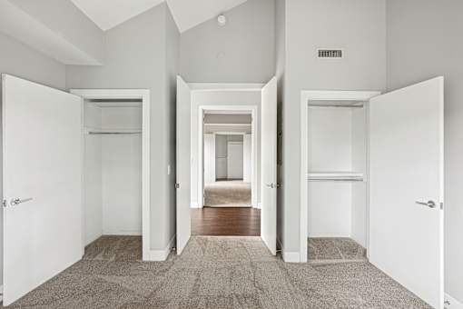 A hallway with white walls and a carpeted floor.