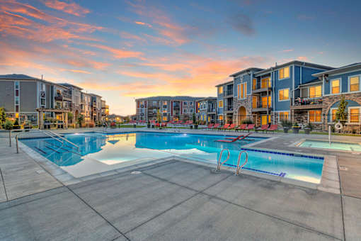 A large swimming pool surrounded by apartment buildings.