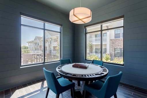 A dining room with a round table and chairs.