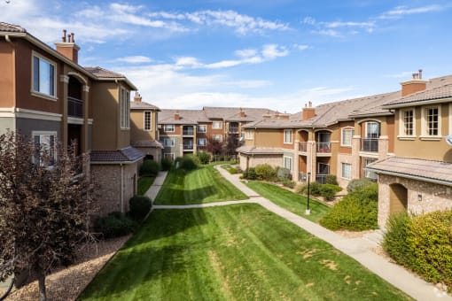 a row of town houses on a green lawn