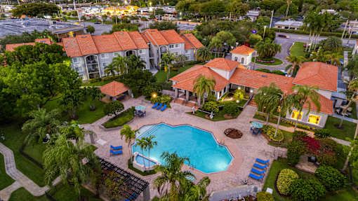 A large building with a pool in front of it.