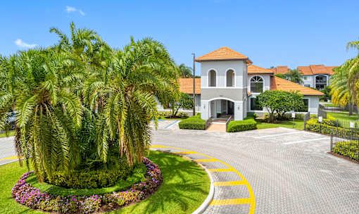 A large house with a red roof and a driveway with a yellow line.
