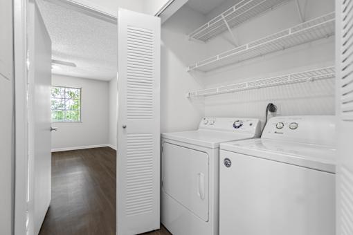 A white laundry room with a washer and dryer.
