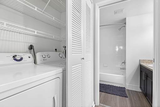A white laundry room with a washer and dryer.