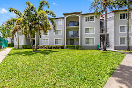 A building with a green lawn in front of it.