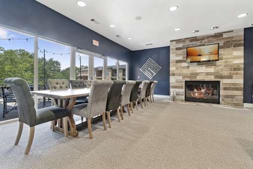 A modern dining room with a fireplace and a large table.