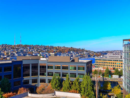an aerial view of a building with a city in the background