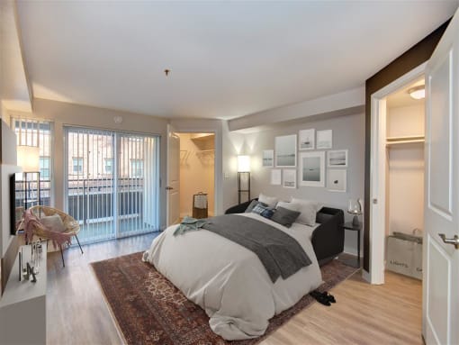 a bedroom with a bed and a door to a balcony