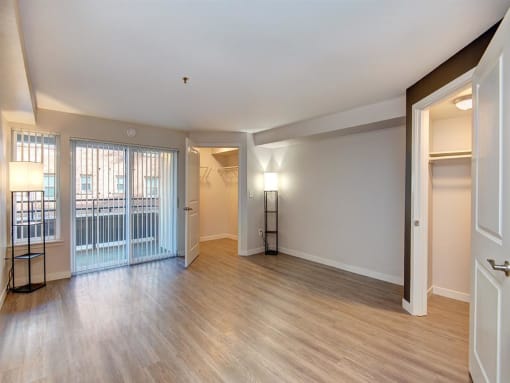 a bedroom with a door leading to a balcony