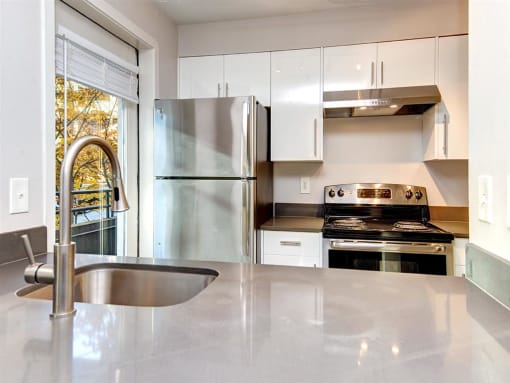 a kitchen with a sink stove and refrigerator