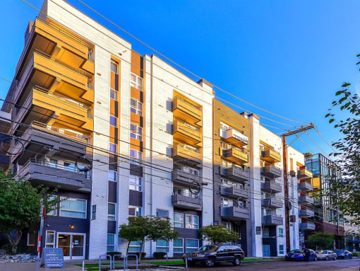 a row of apartment buildings with a blue sky in the background