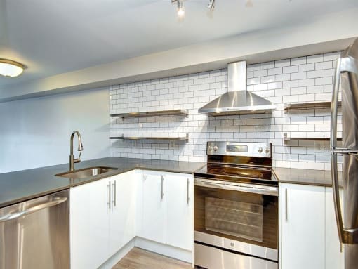 a kitchen with a stove top oven next to a sink