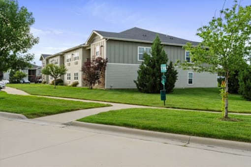 Apartment complex with a green lawn in front.