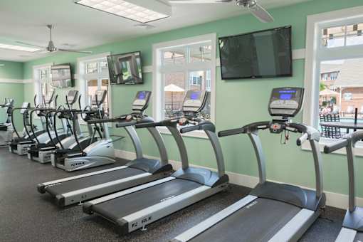 A gym with treadmills and exercise bikes.