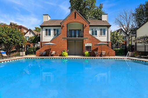 A house with a pool in front.