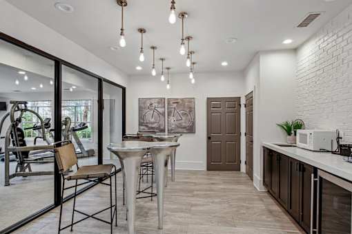 A modern kitchen with a dining table and chairs.