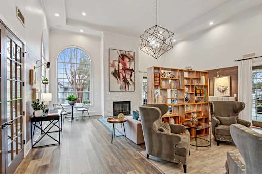A living room with a fireplace and a bookcase.