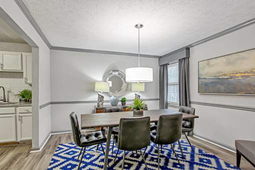 A dining room with a table set for four.