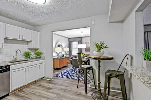 A kitchen with a table and chairs in the middle of the room.