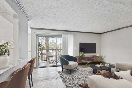 A living room with a television, a chair, a sofa, and a table.