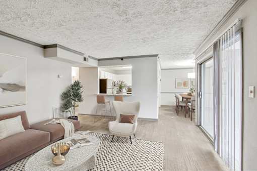 A living room with a brown sofa, a white chair, and a coffee table with a bowl on it.