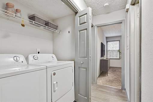 A white washer and dryer in a laundry room.