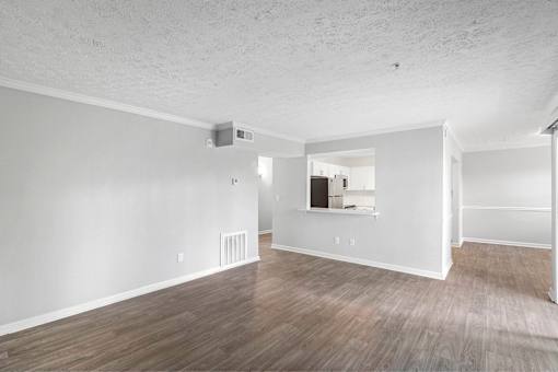 A room with wood flooring and white walls.