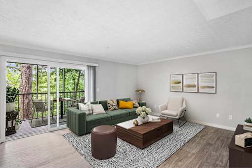 A living room with a green couch and a wooden coffee table.