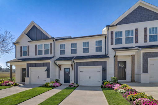 A modern two-story house with a garage on the ground floor.