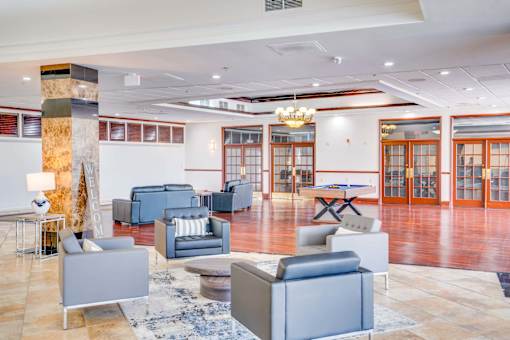 a lobby with couches and chairs and a table