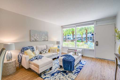 a living room with a large window and a couch