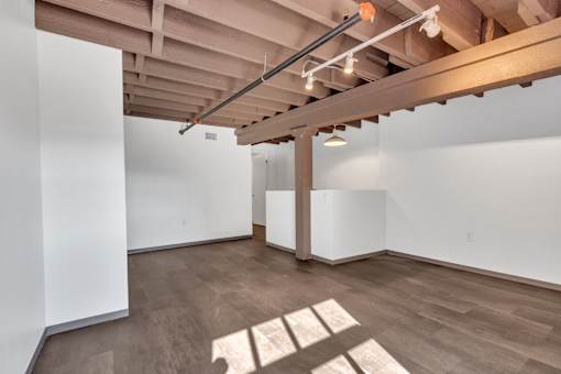 A room with wooden floors and white walls.